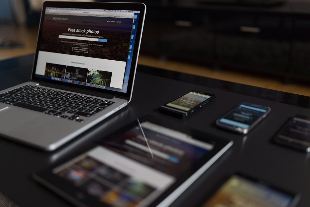 The same website shown on a laptop, tablet and phones, demonstrating responsive design